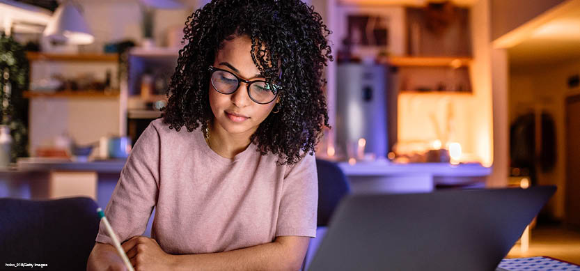 Female wearing glasses and purple shirt studying