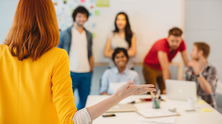 A teacher standing in front of a group of students.
