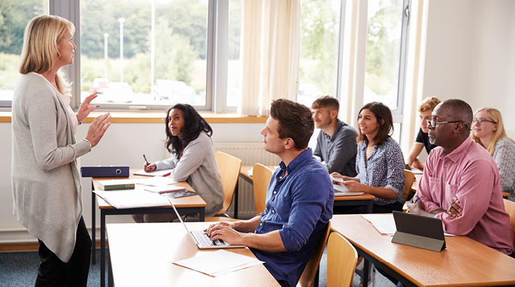 A teacher standing in front of the classroom.