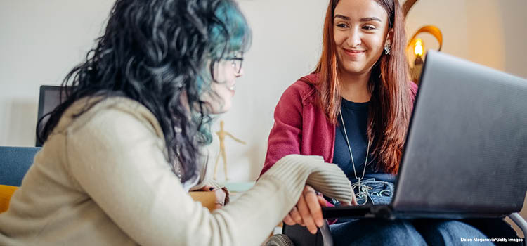 Two female learners smiling in a discussion
