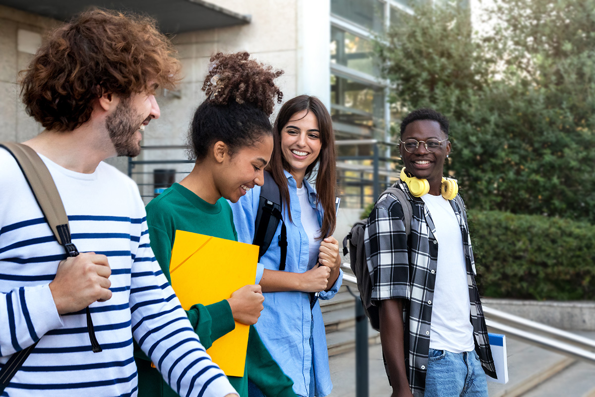 Group of college students walking and smiling 