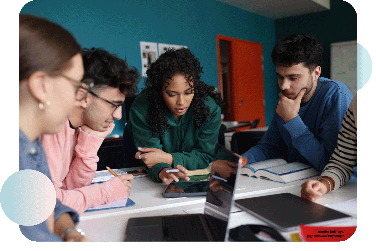 A group of students working together around a table in class