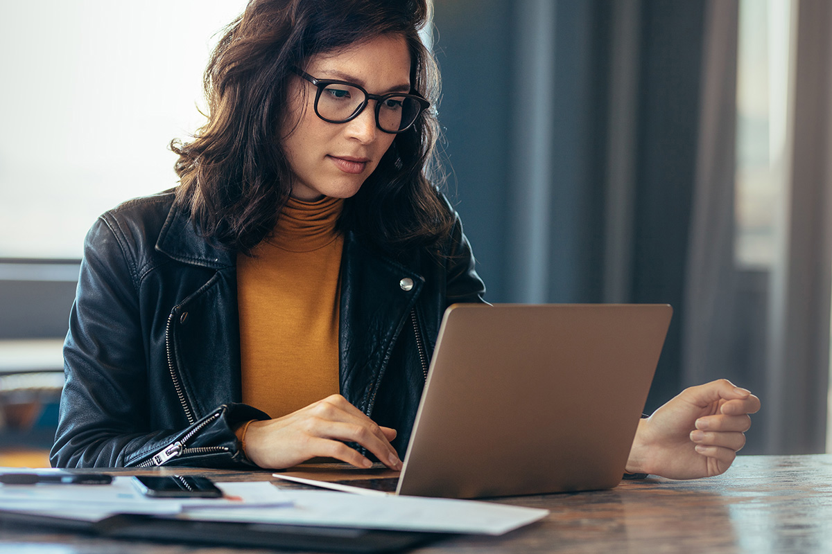 woman busy working on laptop computer at office